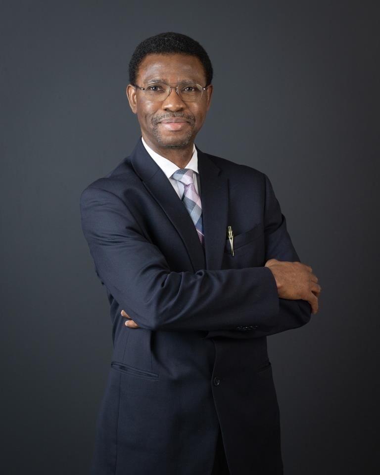 Dr. Emmanuel B. John — executive portrait